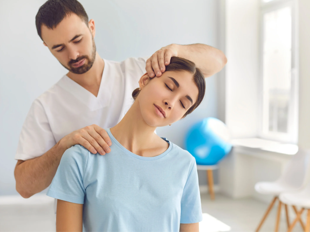 an osteopathic physician man stretching a womans neck with hand on head and shoulders